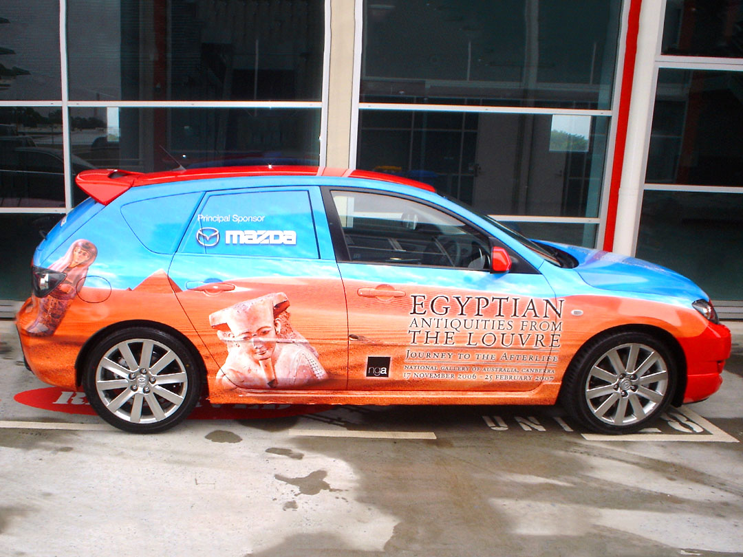 A car fully wrapped in promotional graphics